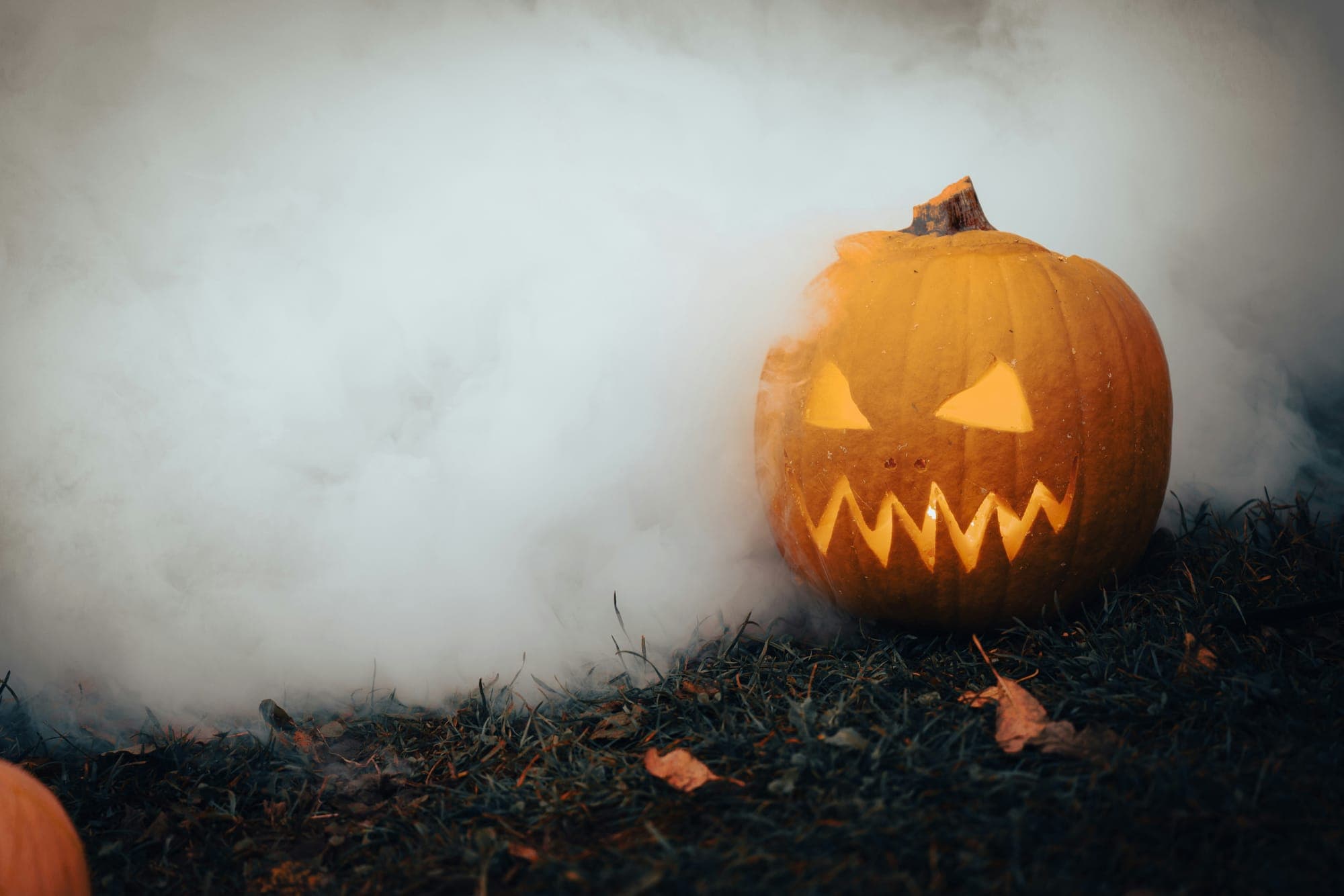 A glowing carved jack-o-lantern in the dark